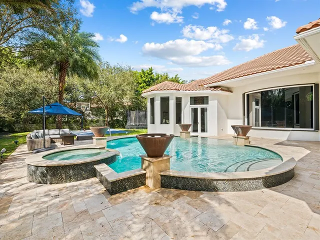 a view of an outdoor space with lounge chairs