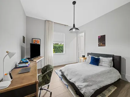 a front view of a house with garden and a yard