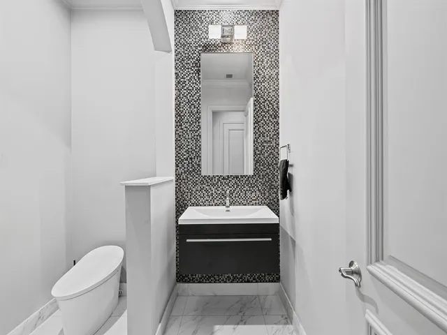 an aerial view of residential houses with outdoor space and trees