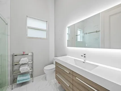 a view of a sign board with large trees