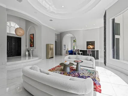 a kitchen with kitchen island granite countertop a stove a sink a oven and a refrigerator with wooden floor