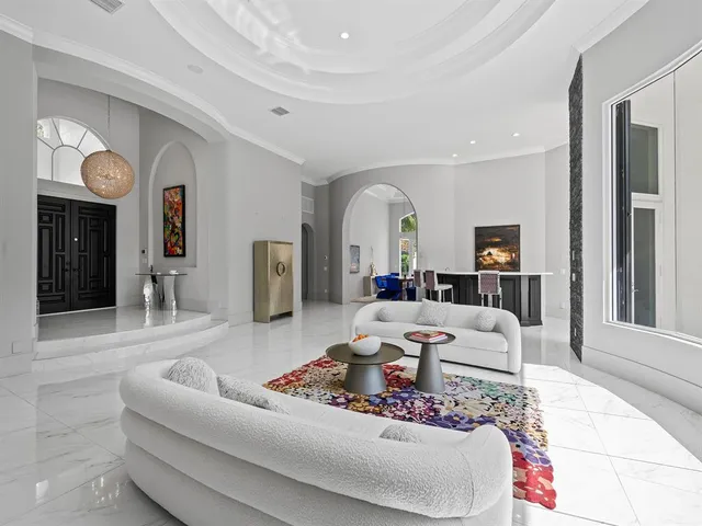 a kitchen with kitchen island granite countertop a stove a sink a oven and a refrigerator with wooden floor