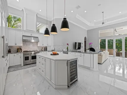 a living room with furniture a flat screen tv and a large window