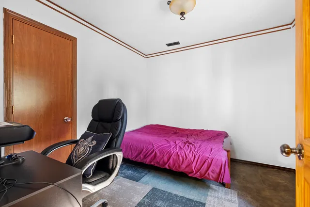 a bedroom with a bed and a dresser