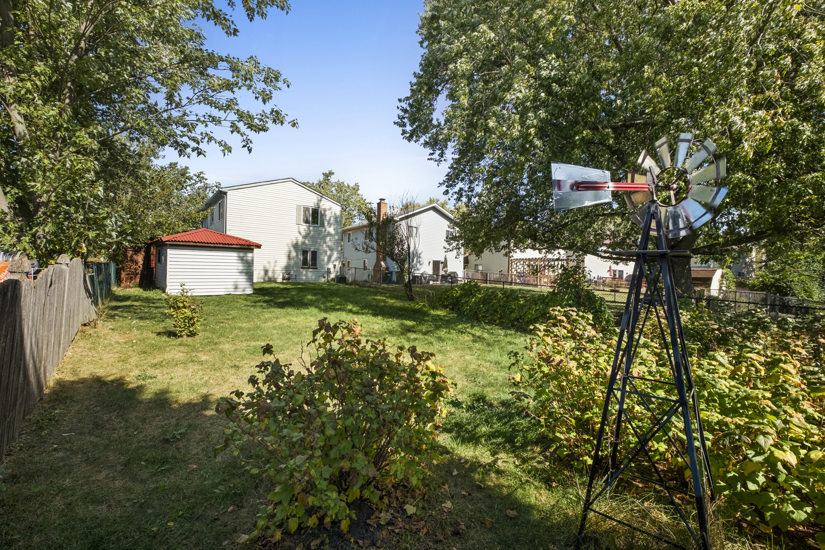 545 Old Stone Road Bolingbrook, IL 60440 - Photo 24 of 28 a backyard of a house with lots of green space and fountain