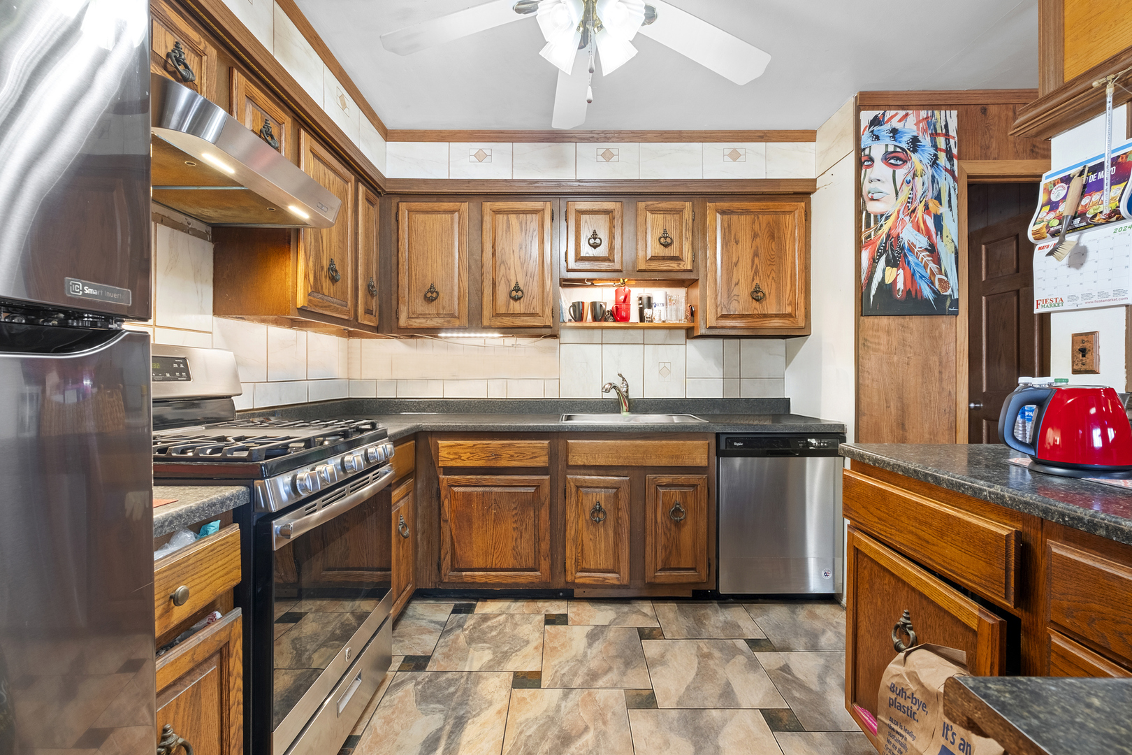 545 Old Stone Road Bolingbrook, IL 60440 - Photo 3 of 28 a kitchen with stainless steel appliances granite countertop a stove a sink and a microwave