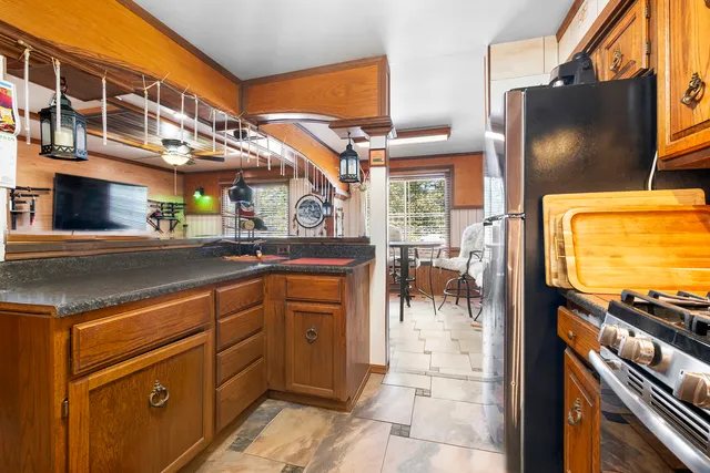 a kitchen with stainless steel appliances a sink and a microwave