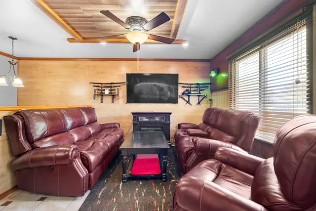 a living room with furniture kitchen view and a large window