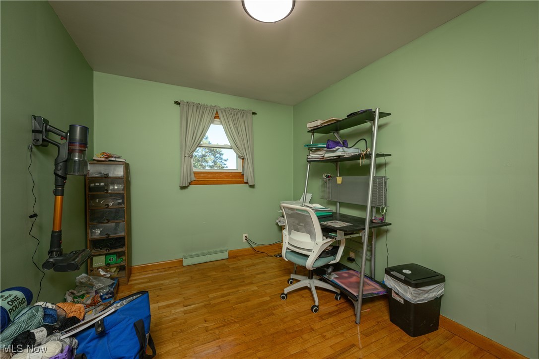 3015 Avalon Road Northwest Carrollton, OH 44615 - Photo 27 of 35 Office area with light wood-style floors and a baseboard heating unit