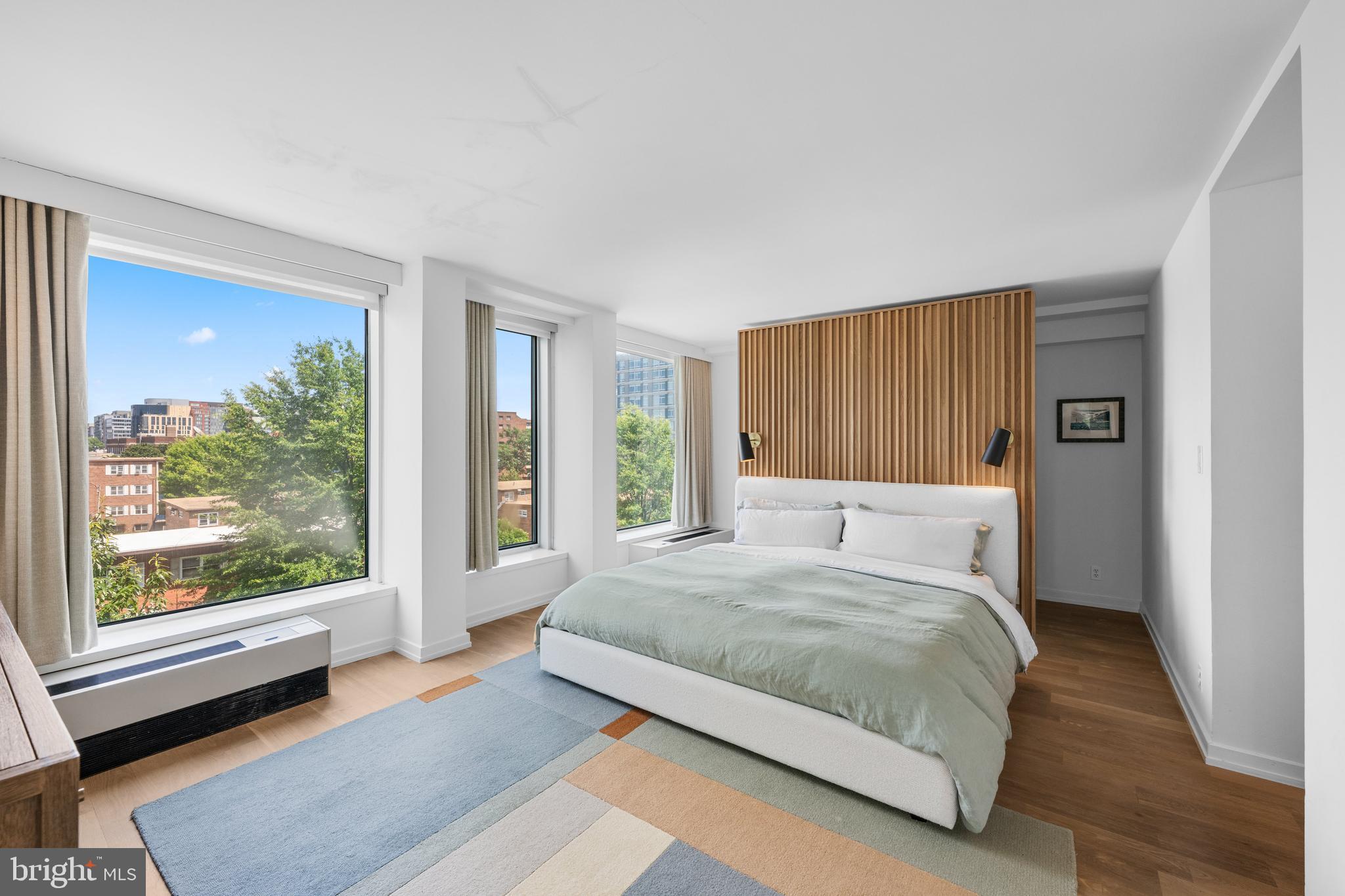 1101 3rd Street Southwest, Unit 315 Washington, DC 20024 - Photo 18 of 38 a bedroom with a large bed and a large window