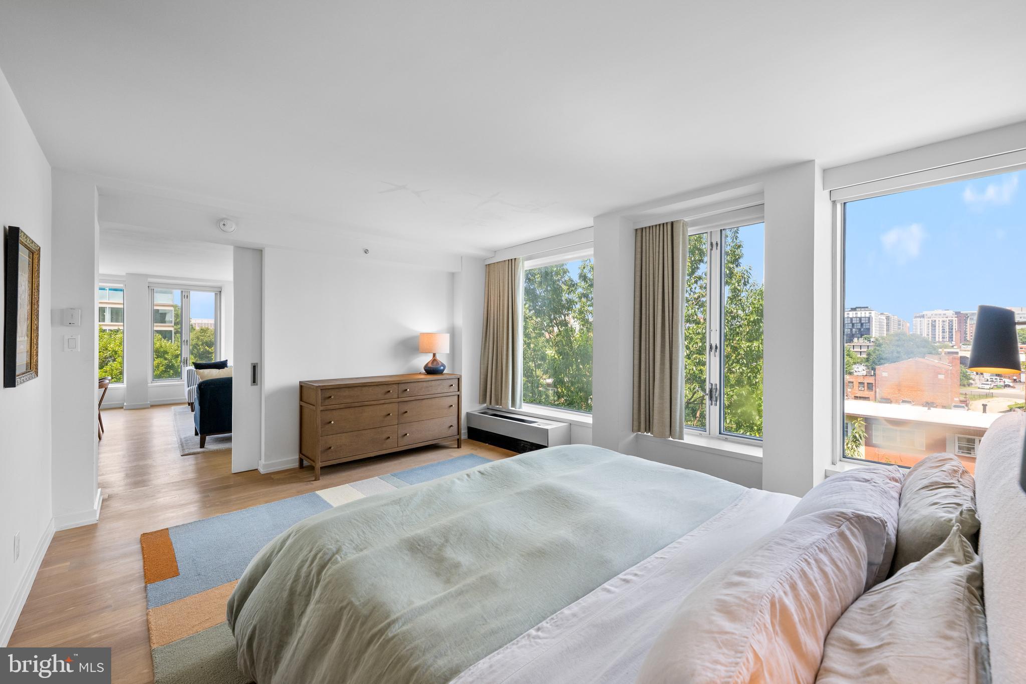 1101 3rd Street Southwest, Unit 315 Washington, DC 20024 - Photo 19 of 38 a bedroom with a large bed and a large window