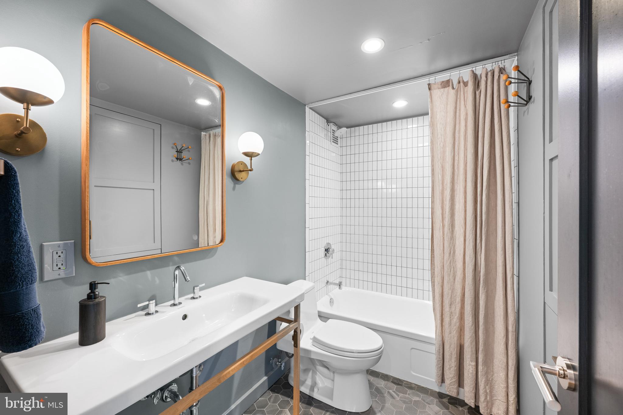 1101 3rd Street Southwest, Unit 315 Washington, DC 20024 - Photo 29 of 38 a bathroom with a double vanity sink toilet mirror and bathtub