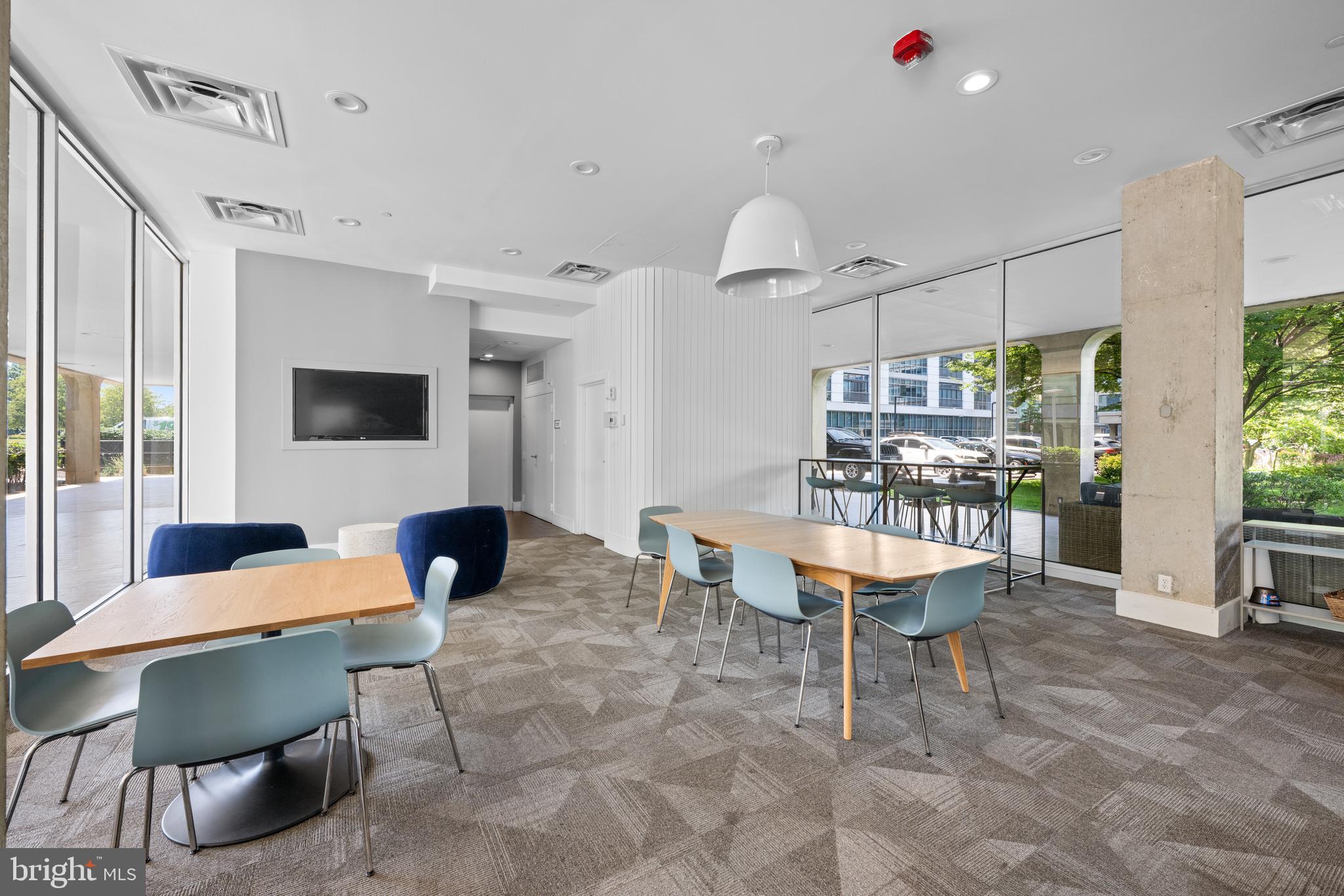 1101 3rd Street Southwest, Unit 315 Washington, DC 20024 - Photo 31 of 38 a outdoor space with furniture a flat screen tv and a large window