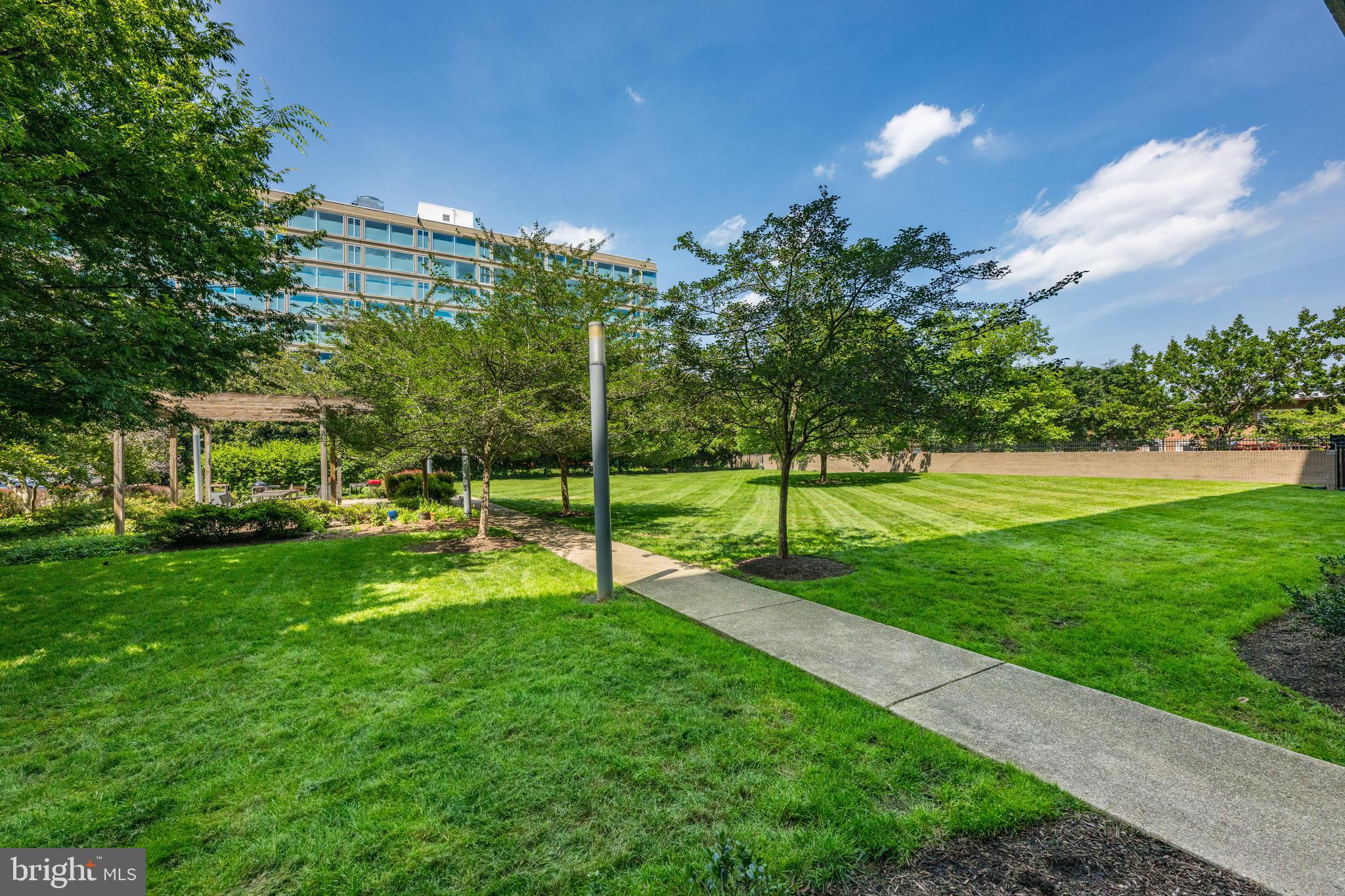 1101 3rd Street Southwest, Unit 315 Washington, DC 20024 - Photo 35 of 38 a view of a house with backyard and a garden