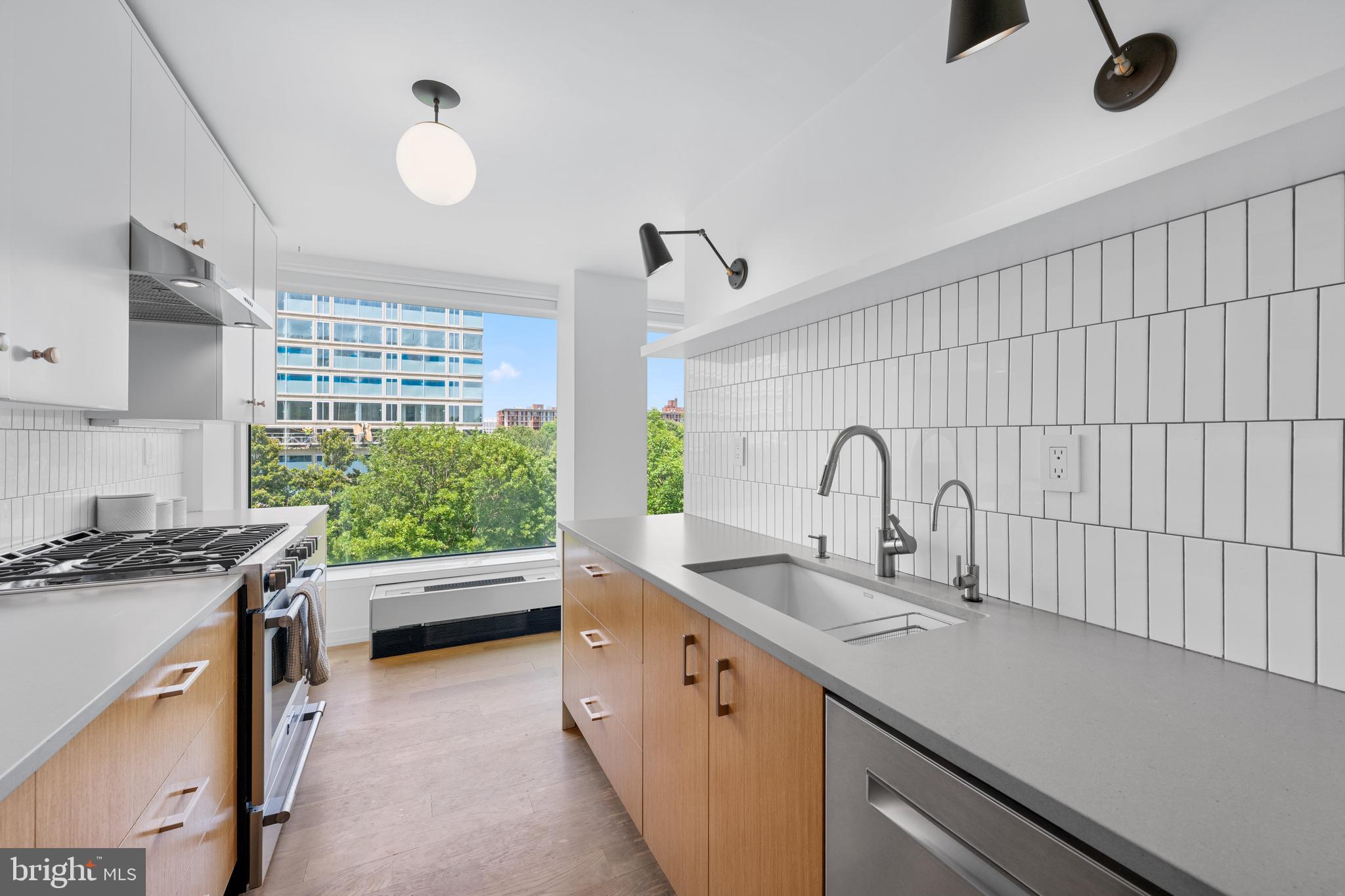 1101 3rd Street Southwest, Unit 315 Washington, DC 20024 - Photo 6 of 38 a kitchen with a sink and a stove top oven