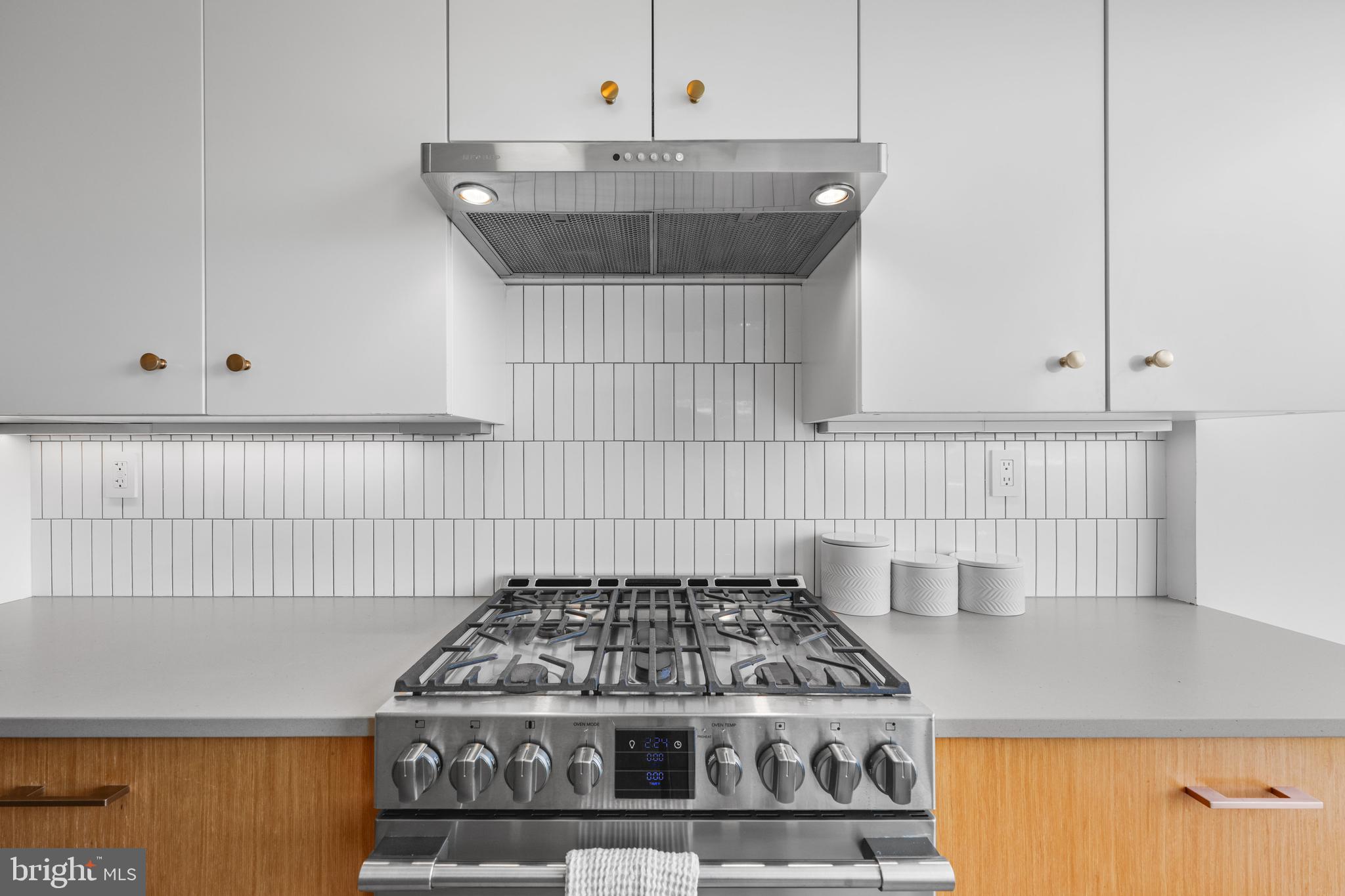 1101 3rd Street Southwest, Unit 315 Washington, DC 20024 - Photo 7 of 38 a kitchen with a stove and white cabinets