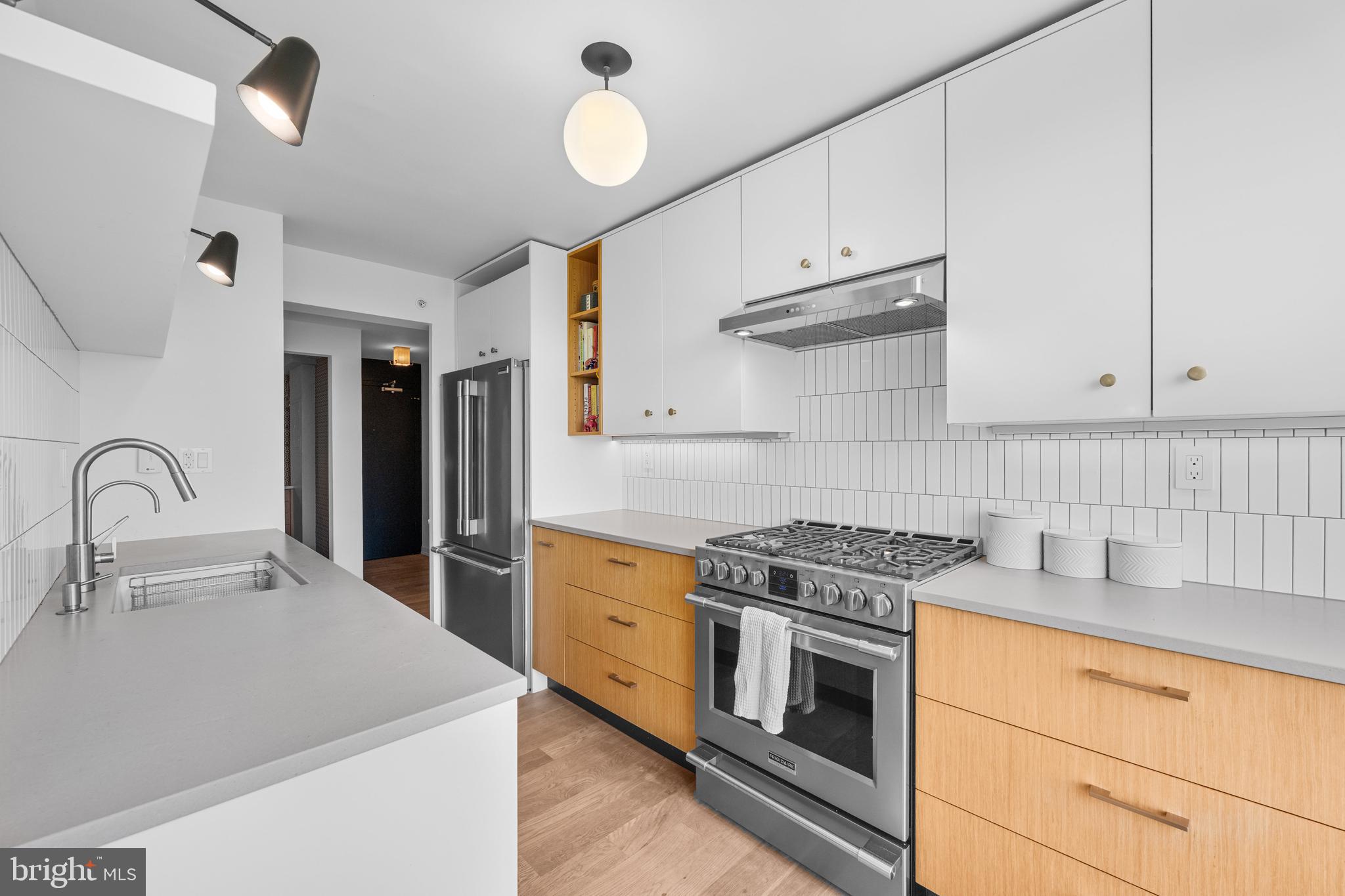 1101 3rd Street Southwest, Unit 315 Washington, DC 20024 - Photo 8 of 38 a kitchen with cabinets appliances and a sink
