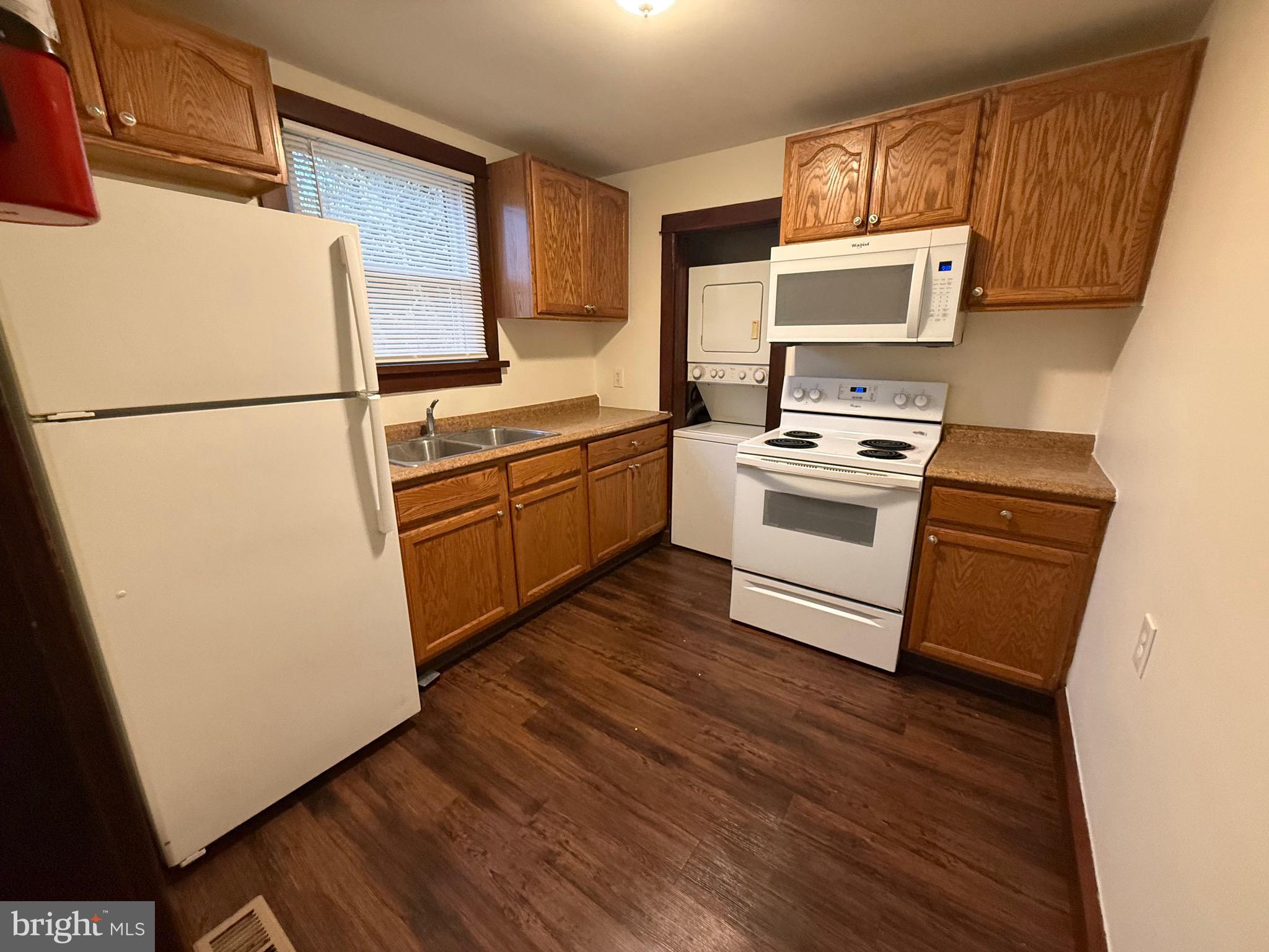 266 Apt B2 Shell Road Carneys Point, NJ 08069 - Photo 6 of 14 a kitchen with wooden cabinets and white appliances