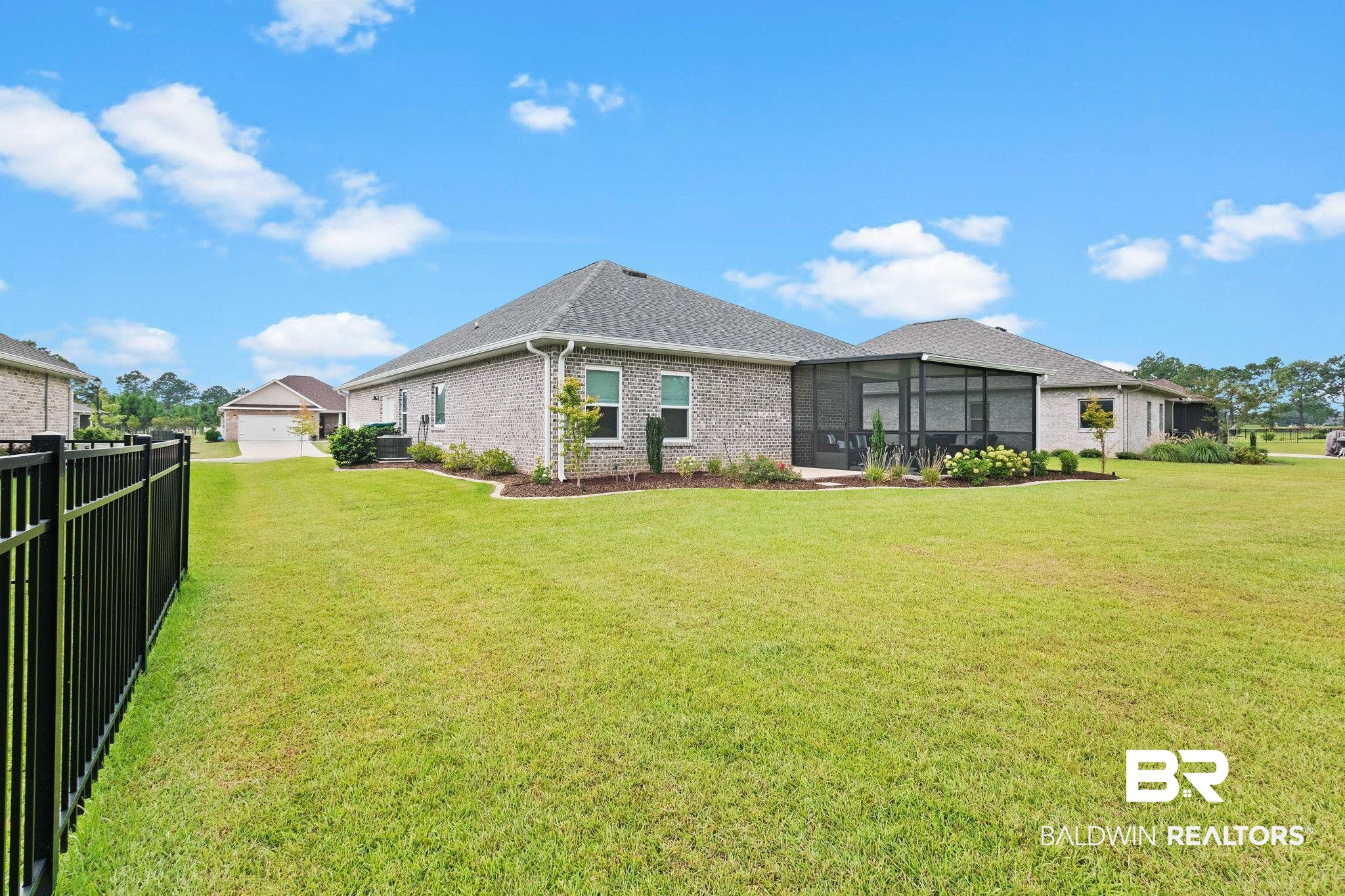 9815 Lakeview Drive Foley, AL 36535 - Photo 69 of 100 Back of house with a sunroom, central AC unit, and a yard