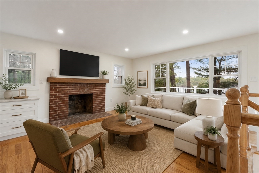 50 Pine Grove Road Lunenburg, MA 01462 - Photo 12 of 42 a living room with furniture a fireplace and a flat screen tv