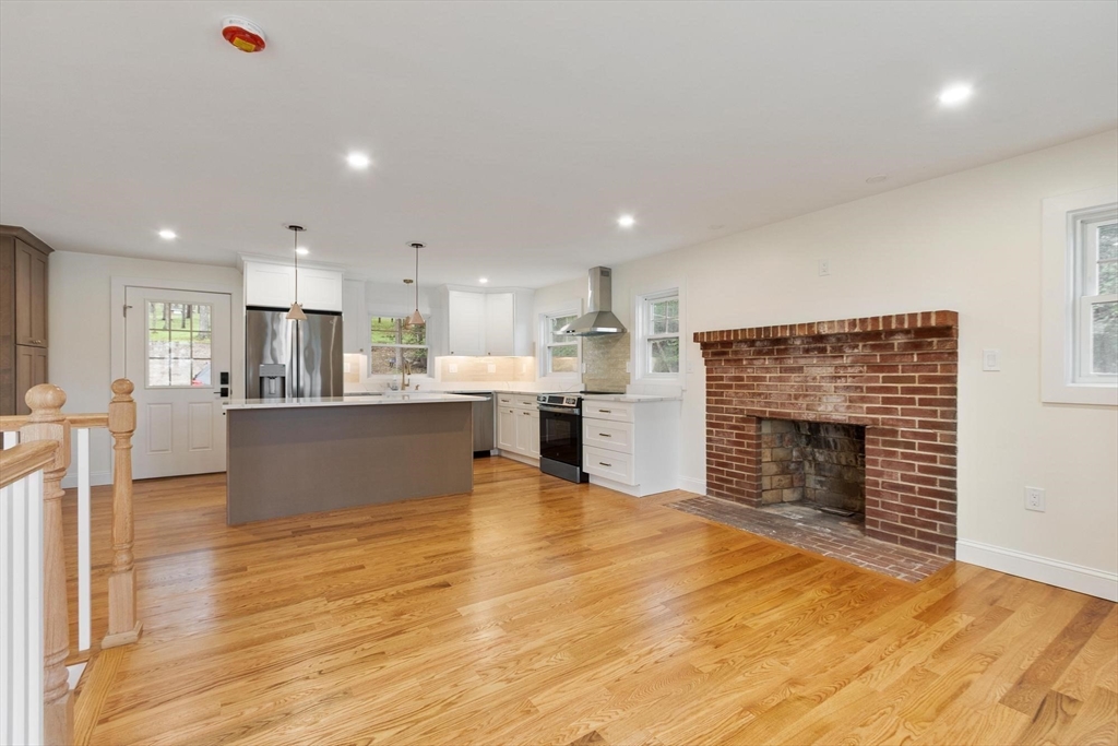 50 Pine Grove Road Lunenburg, MA 01462 - Photo 14 of 42 a view of kitchen and kitchen with fireplace wooden floor