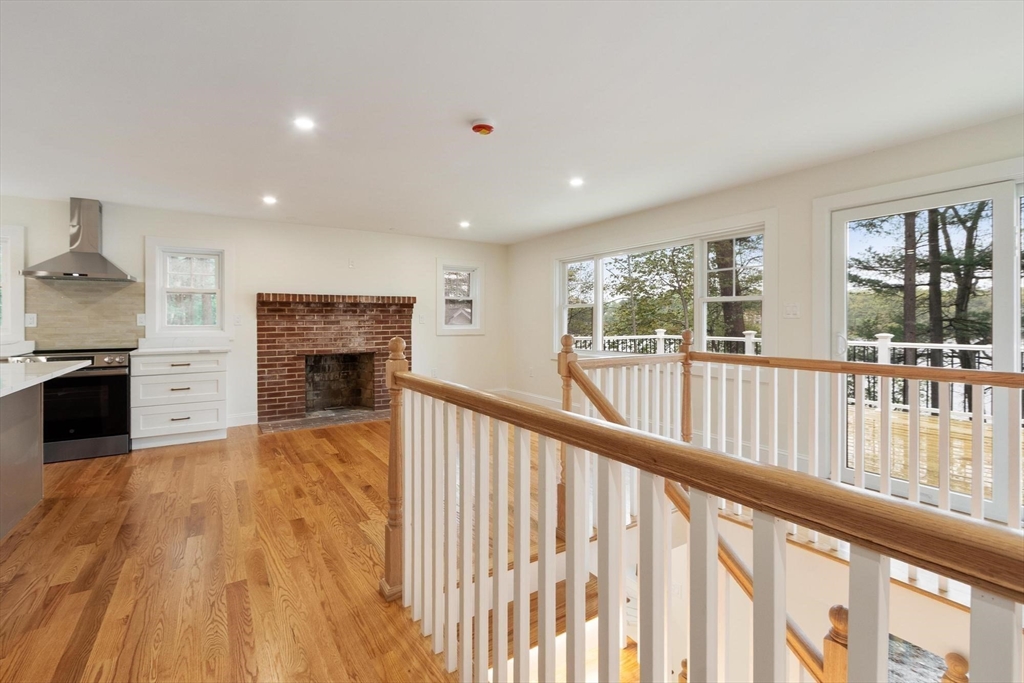 50 Pine Grove Road Lunenburg, MA 01462 - Photo 15 of 42 a view of a living room and kitchen with furniture wooden floor and windows