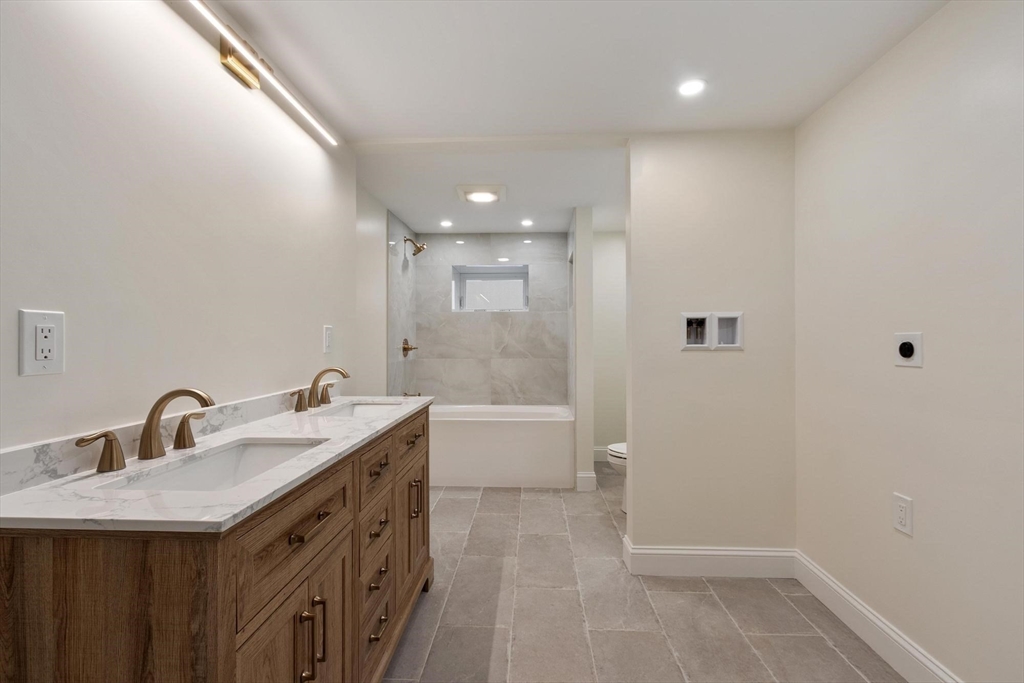 50 Pine Grove Road Lunenburg, MA 01462 - Photo 32 of 42 a bathroom with a double vanity sink a toilet and shower