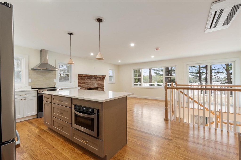 50 Pine Grove Road Lunenburg, MA 01462 - Photo 5 of 42 a kitchen with stainless steel appliances granite countertop a stove and a wooden floors