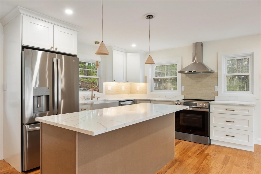 50 Pine Grove Road Lunenburg, MA 01462 - Photo 6 of 42 a kitchen with stainless steel appliances granite countertop a refrigerator a stove and a sink