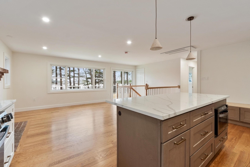 50 Pine Grove Road Lunenburg, MA 01462 - Photo 8 of 42 a kitchen with a sink a chandelier stainless steel appliances and cabinets