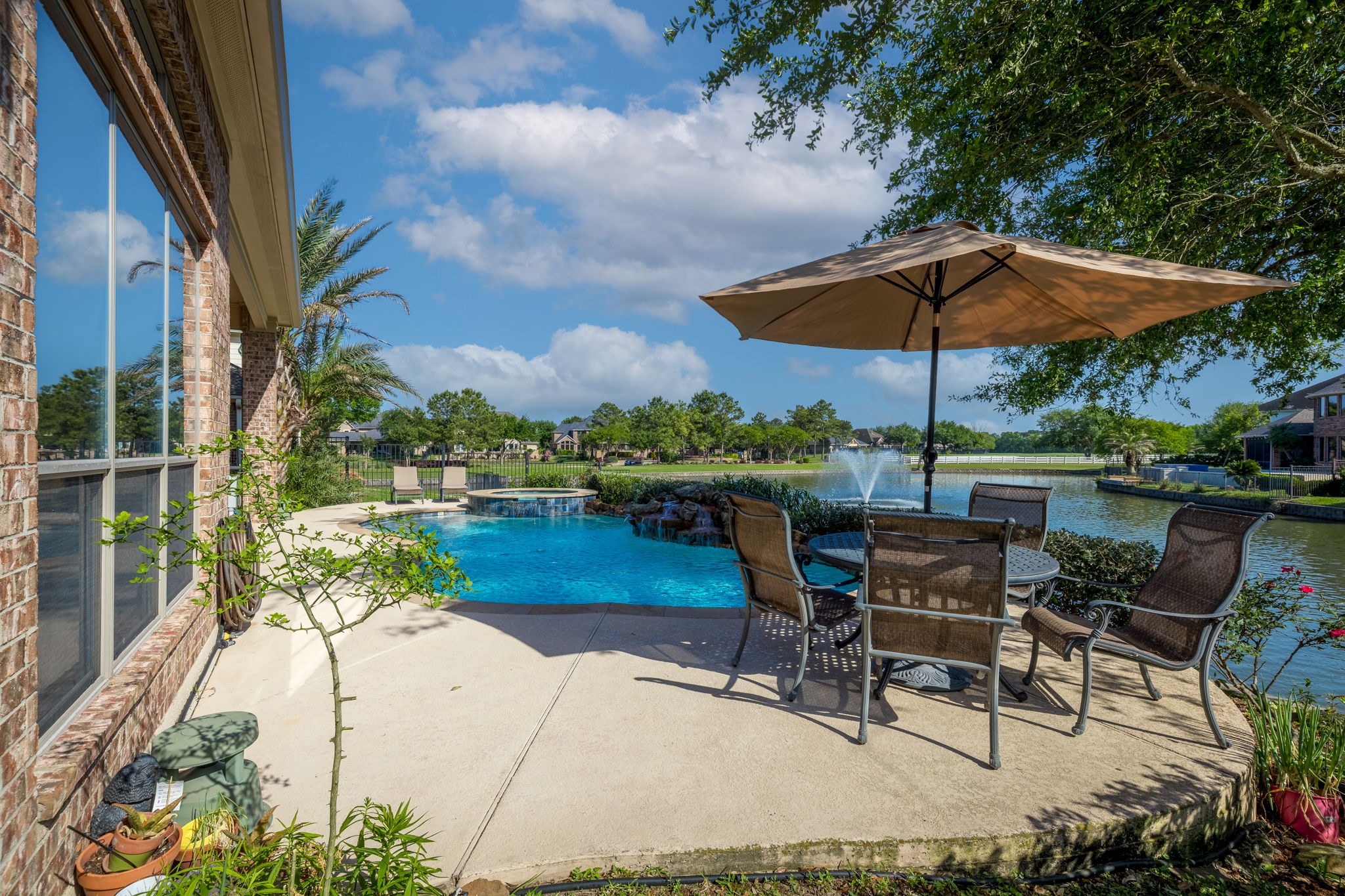 8411 Middle Canyon Road Katy, TX 77494 - Photo 12 of 49 an outdoor space with furniture and umbrella
