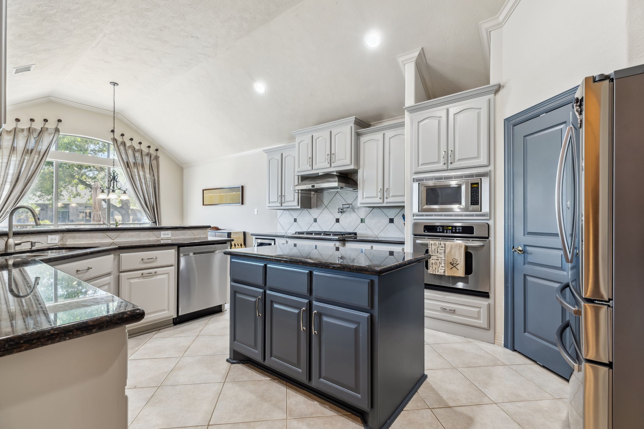 8411 Middle Canyon Road Katy, TX 77494 - Photo 23 of 49 a kitchen with stainless steel appliances granite countertop a refrigerator and a stove top oven