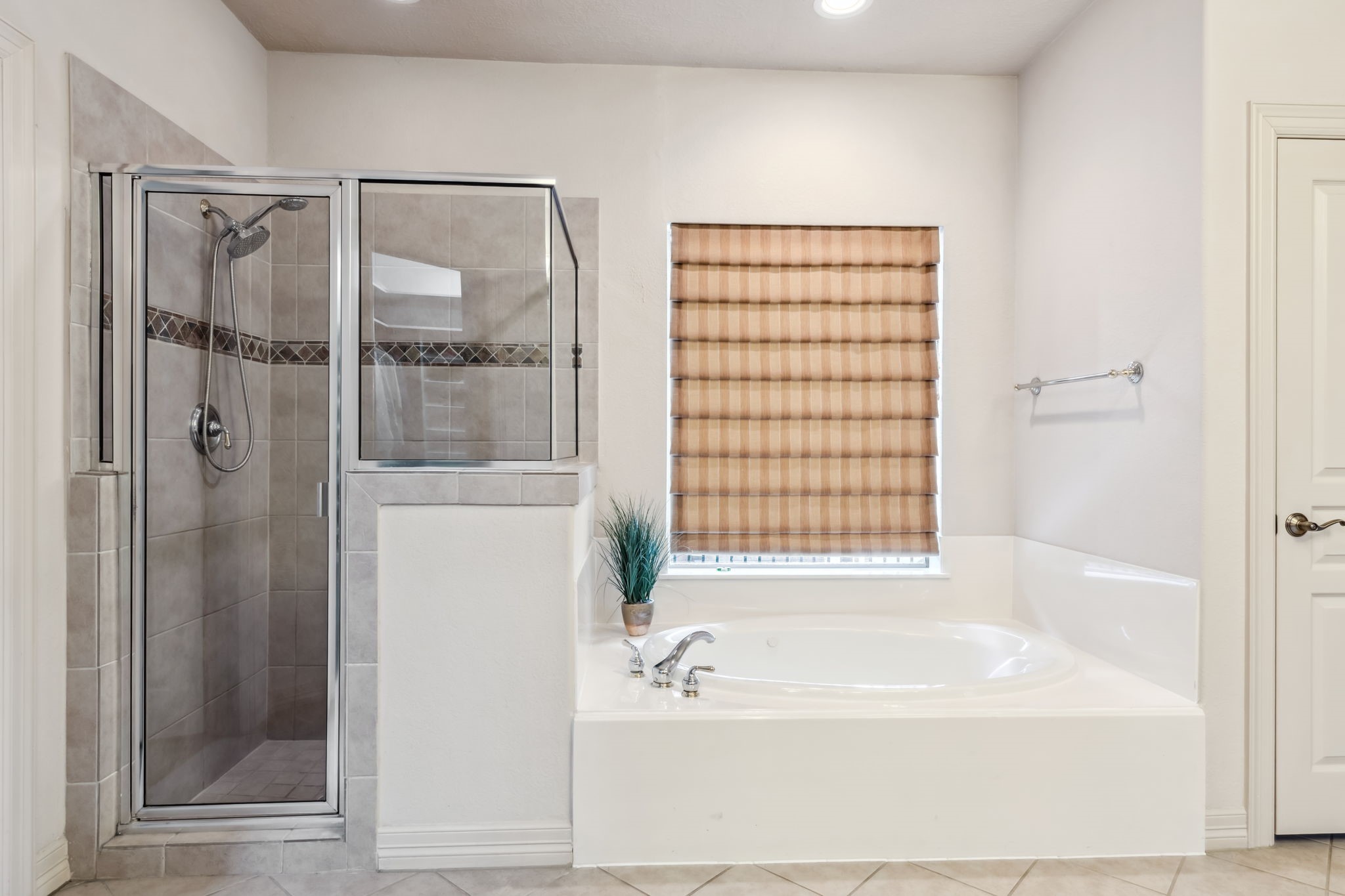 8411 Middle Canyon Road Katy, TX 77494 - Photo 33 of 49 a bathroom with a bathtub and a shower