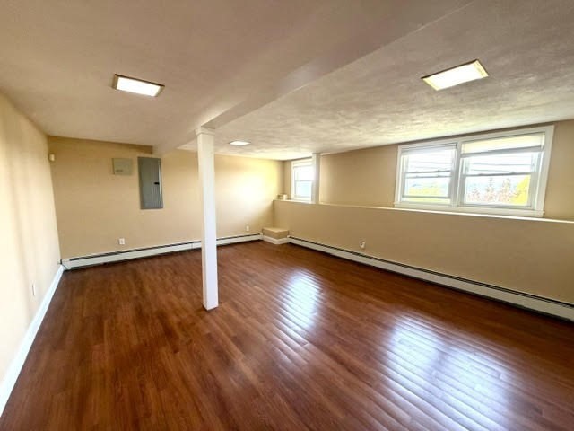 116 Upton Road Waltham, MA 02452 - Photo 18 of 22 an empty room with wooden floor and windows