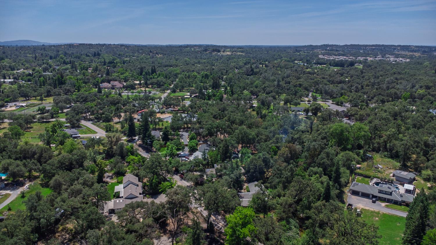 6332 Horseshoe Bar Road Loomis, CA 95650 - Photo 75 of 85 Expansive aerial perspective showcasing a residential area enveloped by abundant mature trees and verdant landscapes