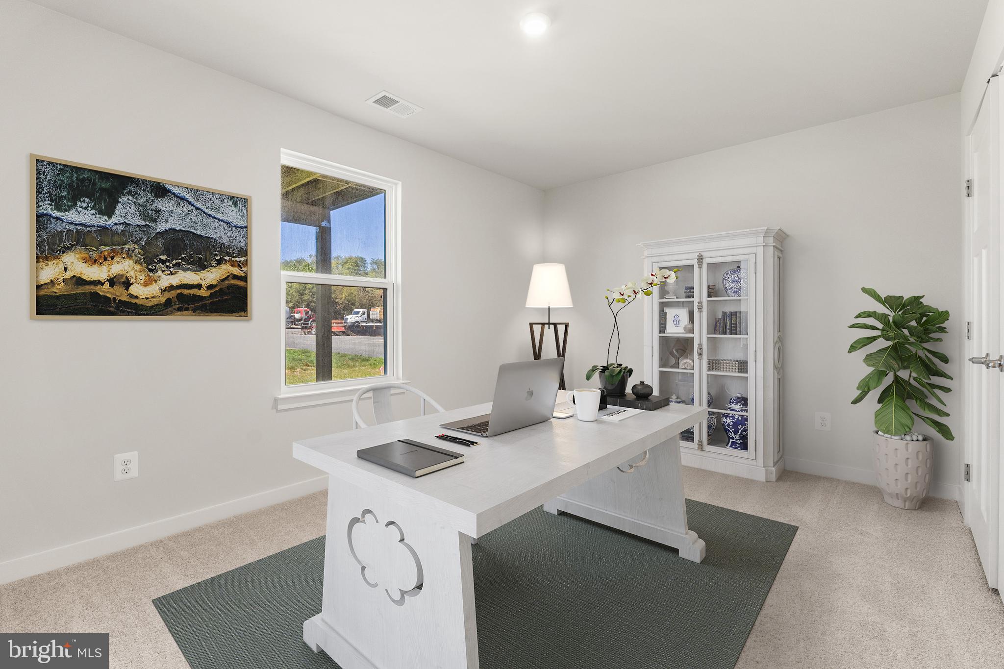 a view of a workspace with furniture and a potted plant