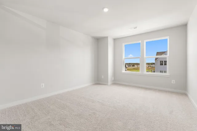 a spacious bedroom with a large bed and a window