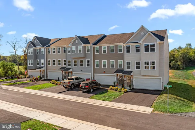 a view of multiple houses with a yard