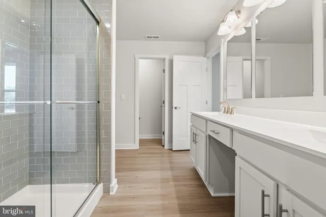a spacious bathroom with a double vanity sink mirror and