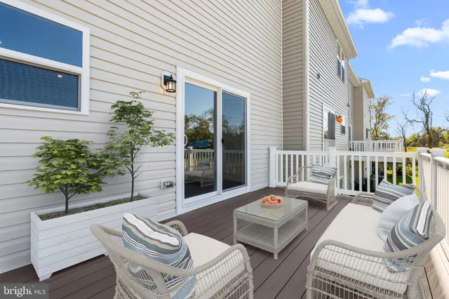 a balcony with furniture and a potted plant