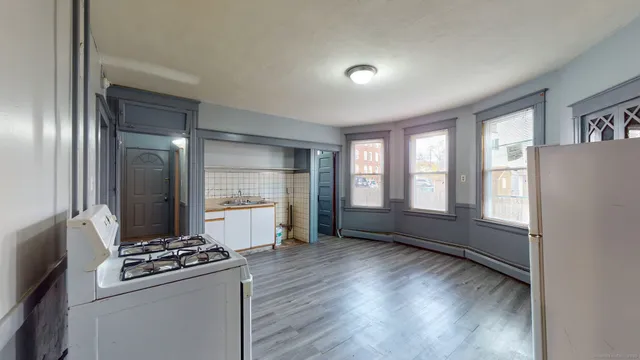 a kitchen with a refrigerator and a stove top oven