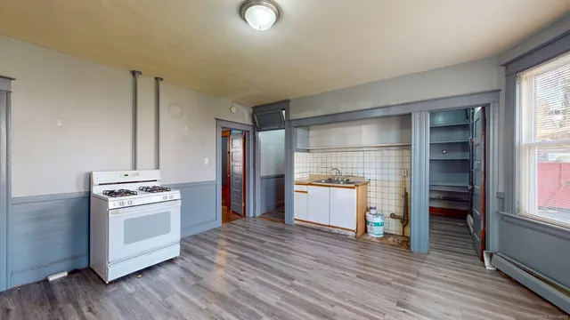 a kitchen with a stove top oven and refrigerator