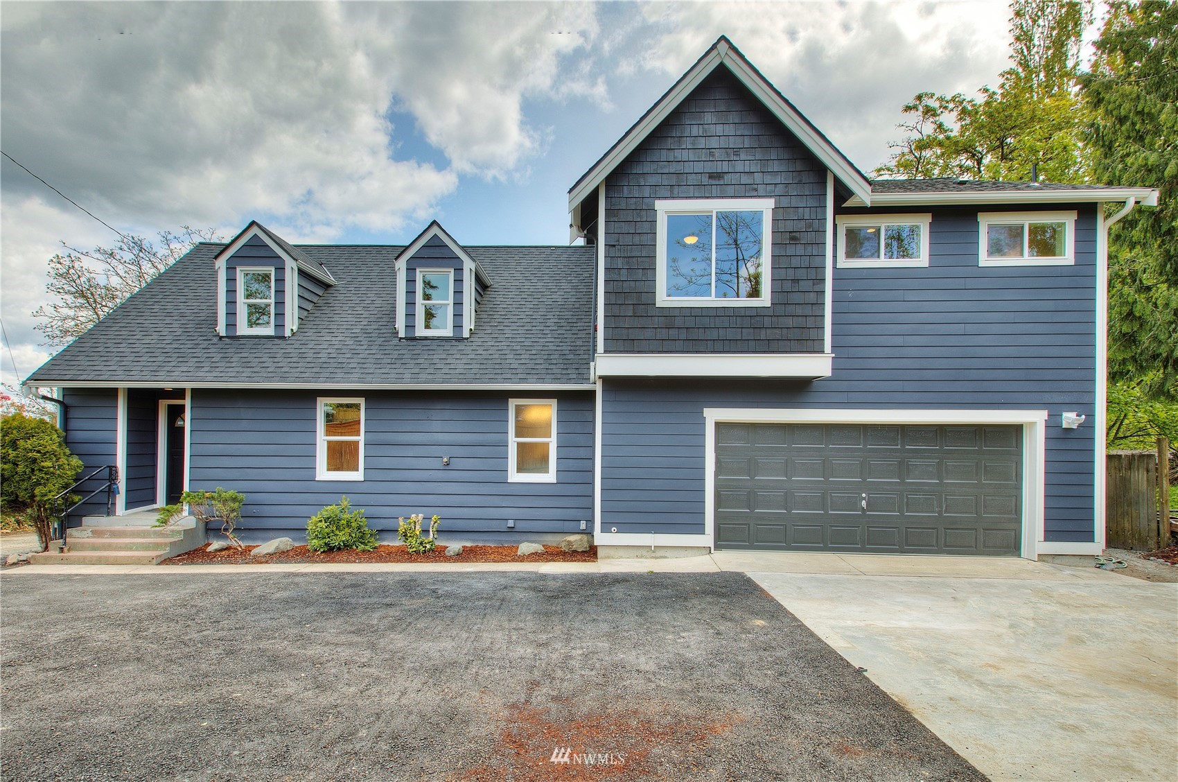 12222 Military Road South Seattle, WA 98168 - Photo 1 of 33 a front view of a house with a yard and garage
