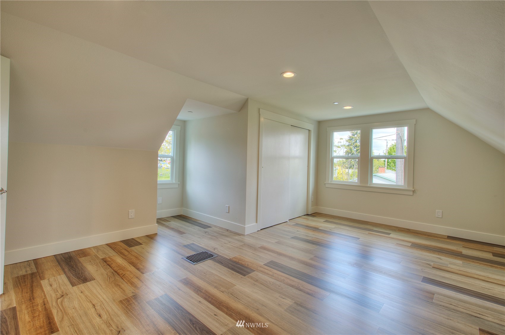 12222 Military Road South Seattle, WA 98168 - Photo 19 of 33 an empty room with wooden floor and windows