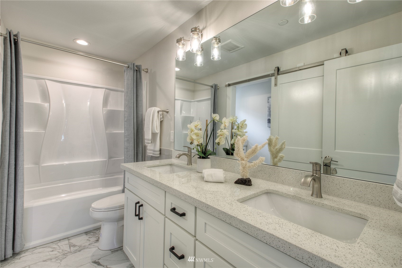 12222 Military Road South Seattle, WA 98168 - Photo 20 of 33 a bathroom with a granite countertop sink a toilet and shower
