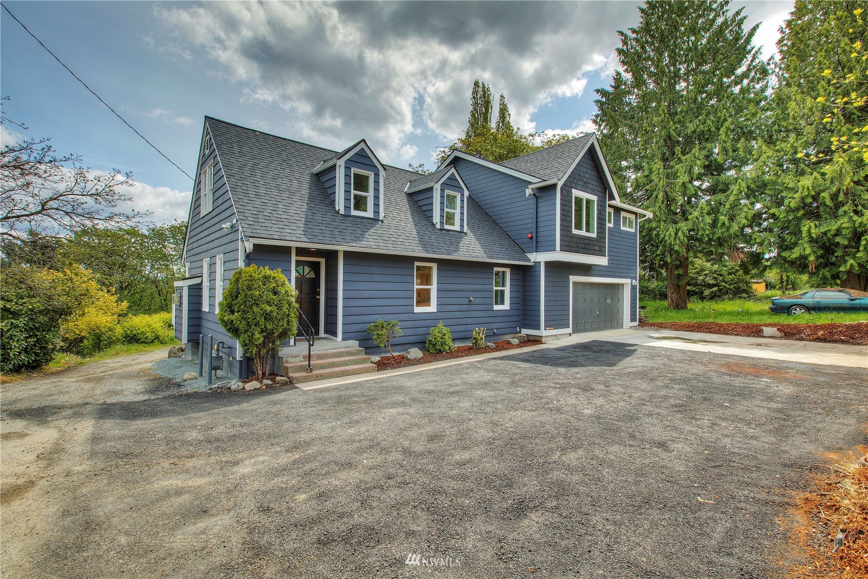 12222 Military Road South Seattle, WA 98168 - Photo 2 of 33 a view of a brick house with a yard and plants