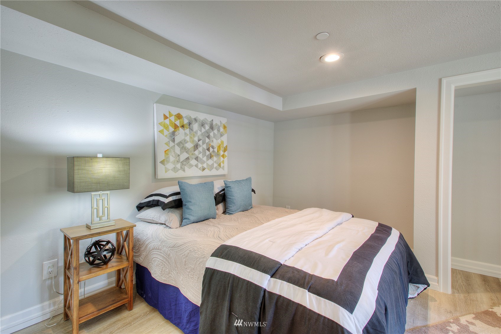 12222 Military Road South Seattle, WA 98168 - Photo 27 of 33 a bedroom with double bed and a night stand