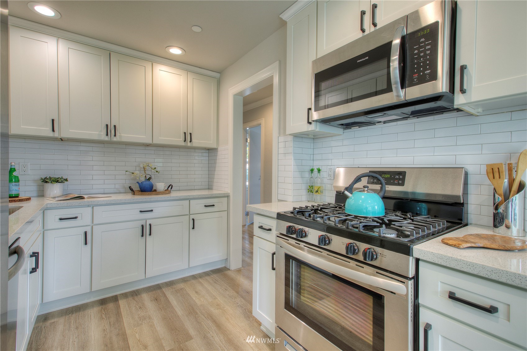 12222 Military Road South Seattle, WA 98168 - Photo 6 of 33 a kitchen with stainless steel appliances granite countertop white cabinets a stove a sink and dishwasher