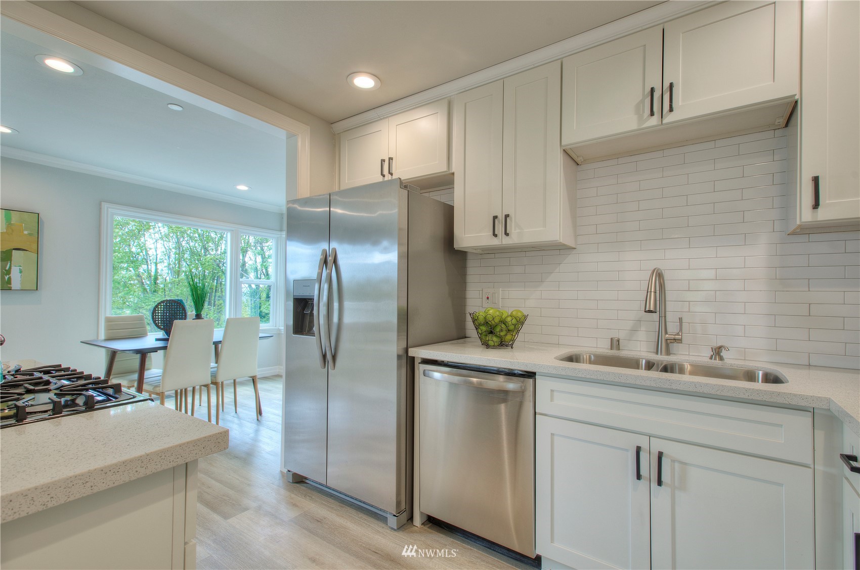 12222 Military Road South Seattle, WA 98168 - Photo 7 of 33 a kitchen with white cabinets and appliances