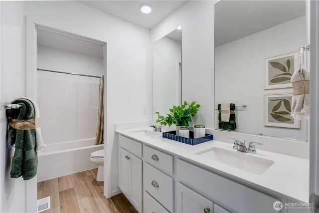 a bathroom with a granite countertop sink a mirror and a shower